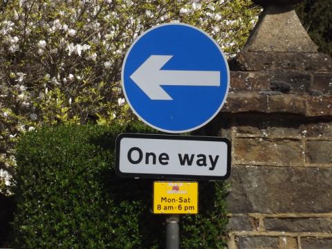 One way sign on a British street.
